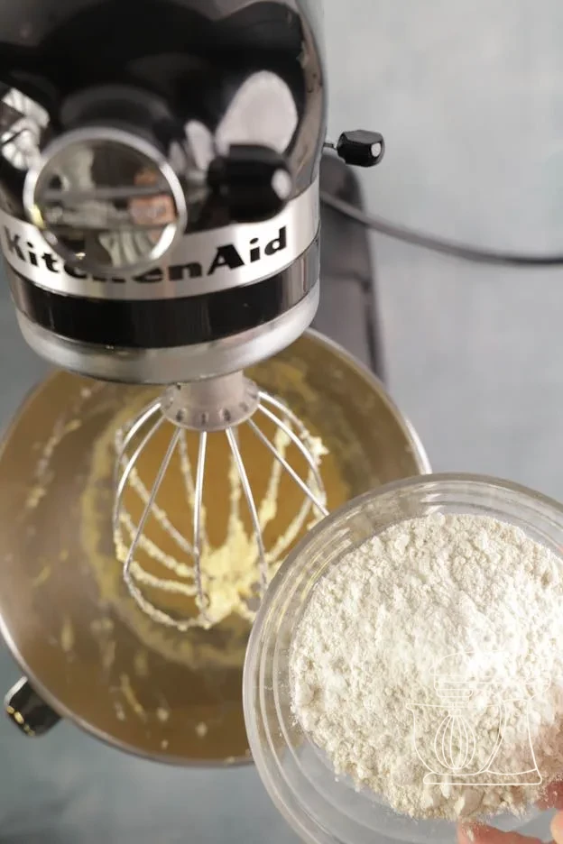 Milk poured into the batter · Baking powder measured with the Measuring spoon · Flour sifted over the batter