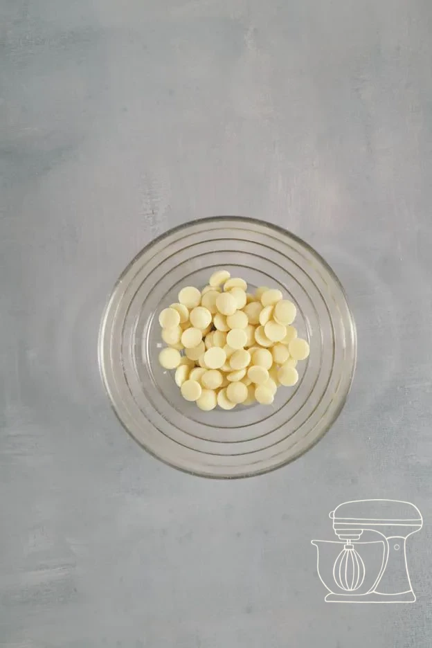 White chocolate melting in the microwave · Melted white chocolate added to the batter · Pale batter with white chocolate stirred through