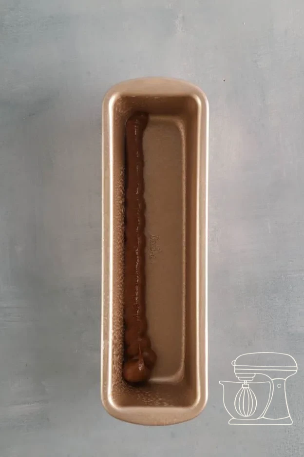 Three batter colours piped alternately into the cake tin · Cake tin filled with alternating batter stripes