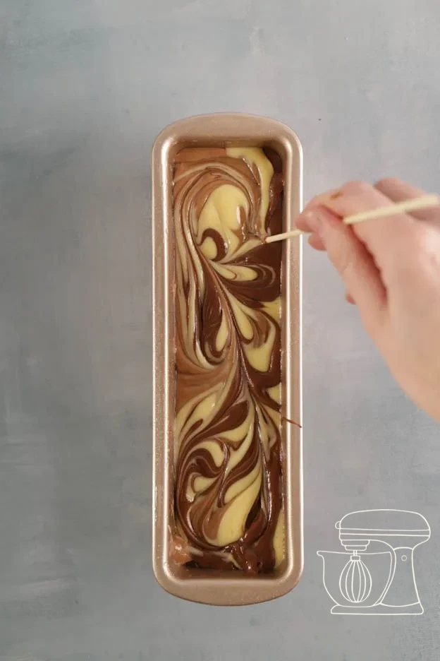 Three batter colours piped alternately into the cake tin