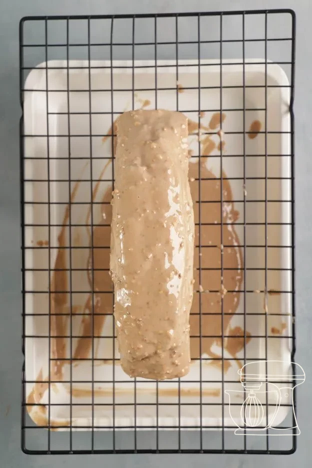 Caramel chocolate icing poured over the marble cake