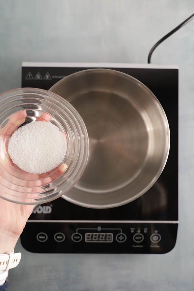 Saucepan heating sugar to prepare a dry caramel