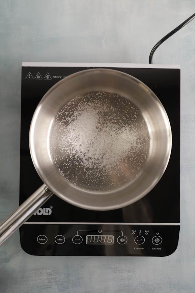 Base layer of sugar caramelising in a saucepan