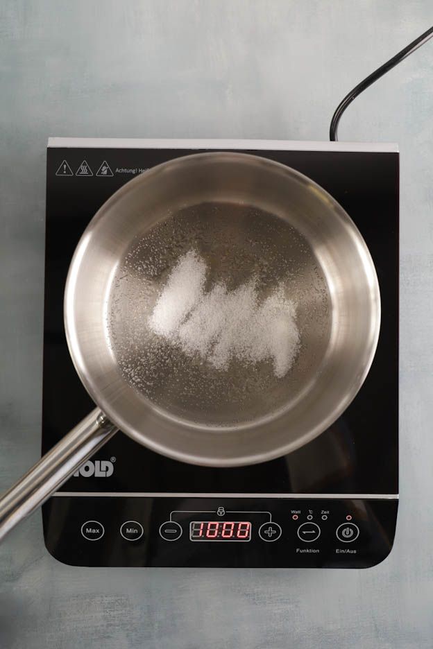 Dry caramel being prepared with a golden colour