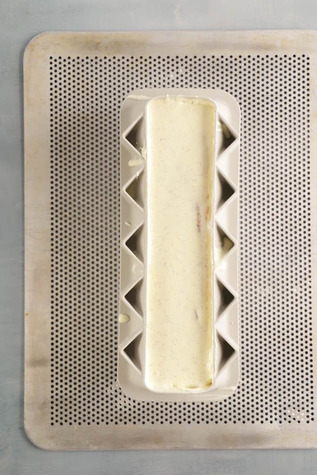 Decorating the yule log with white velvet spray