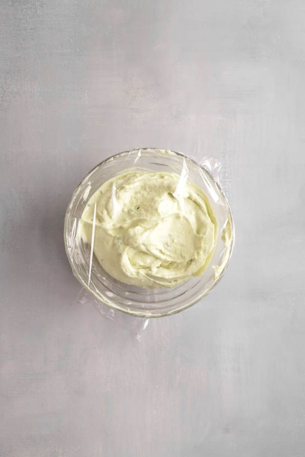 Finely blended pale green avocado cream in a glass bowl for the brick tartlets