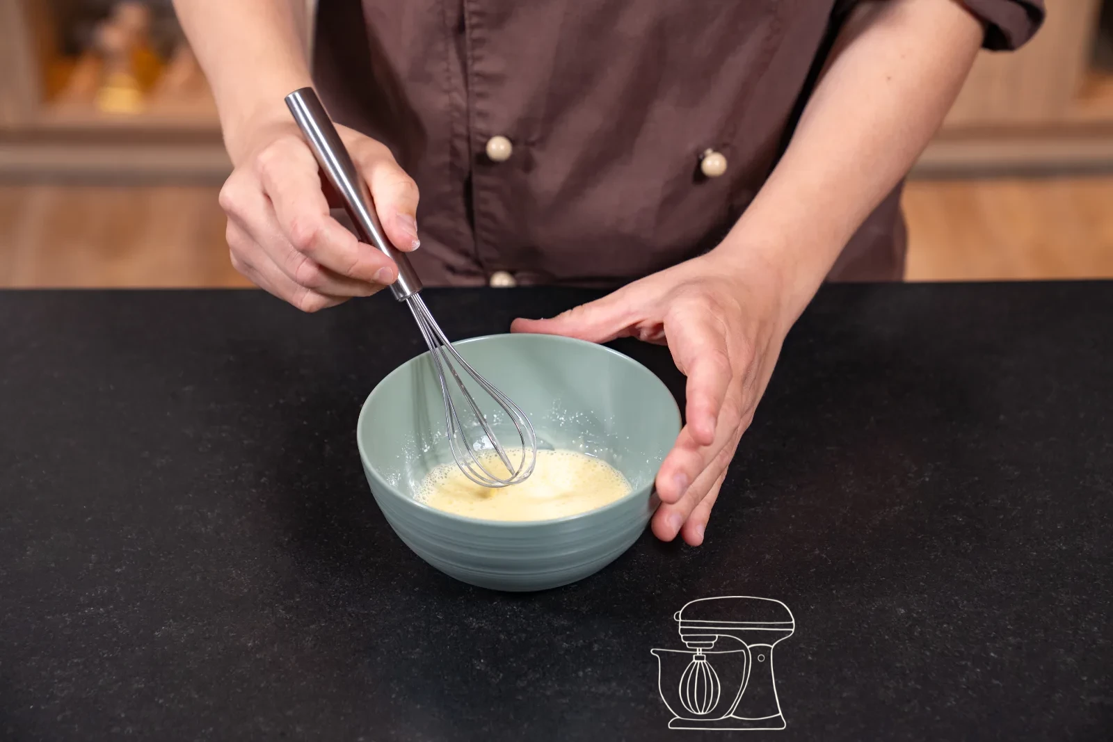 Thickened vanilla cream being stirred in the pot with a whisk, with a bowl and cling film beside it