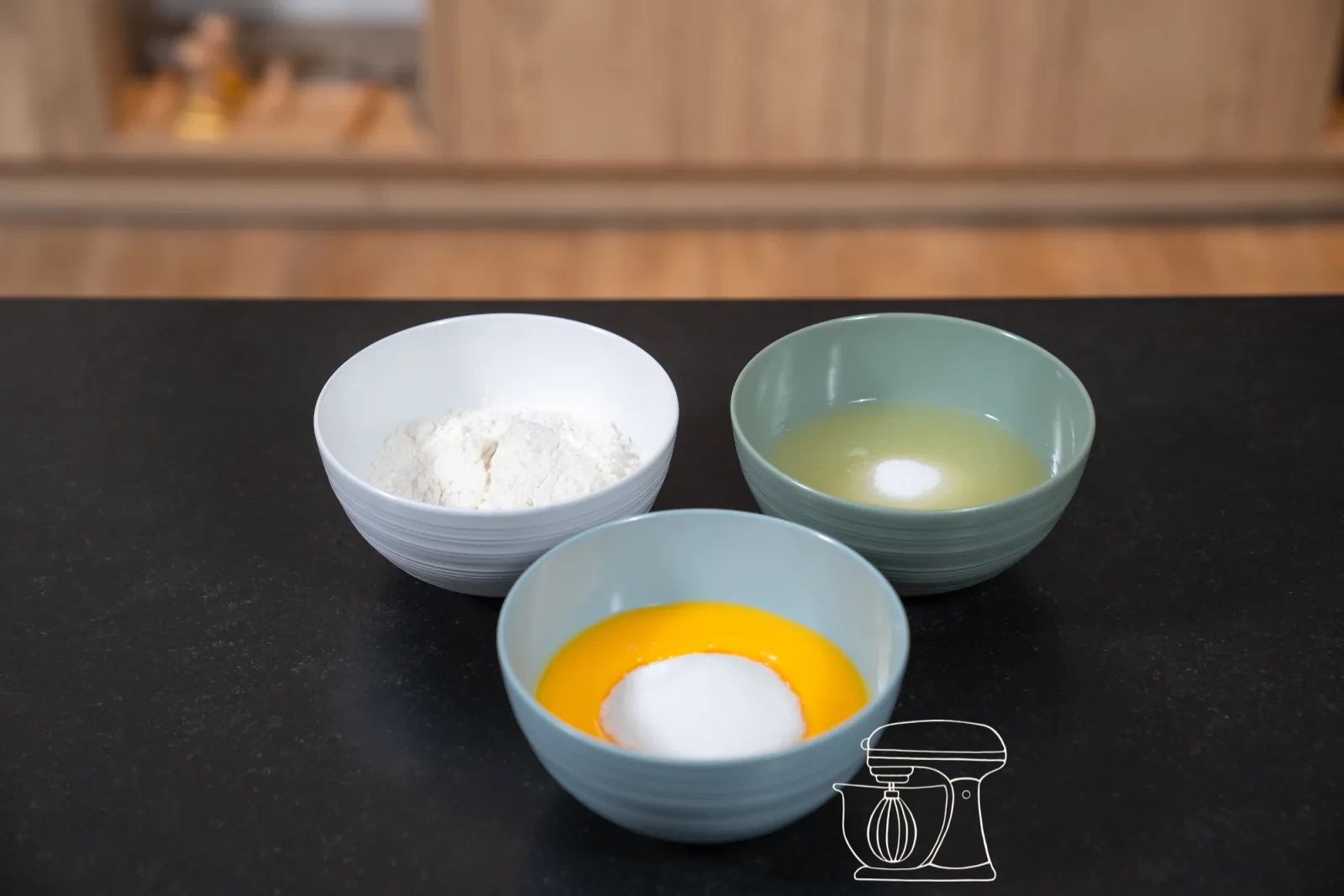 Pale egg-yolk-and-sugar foam in a bowl, with glossy whipped egg white beside it