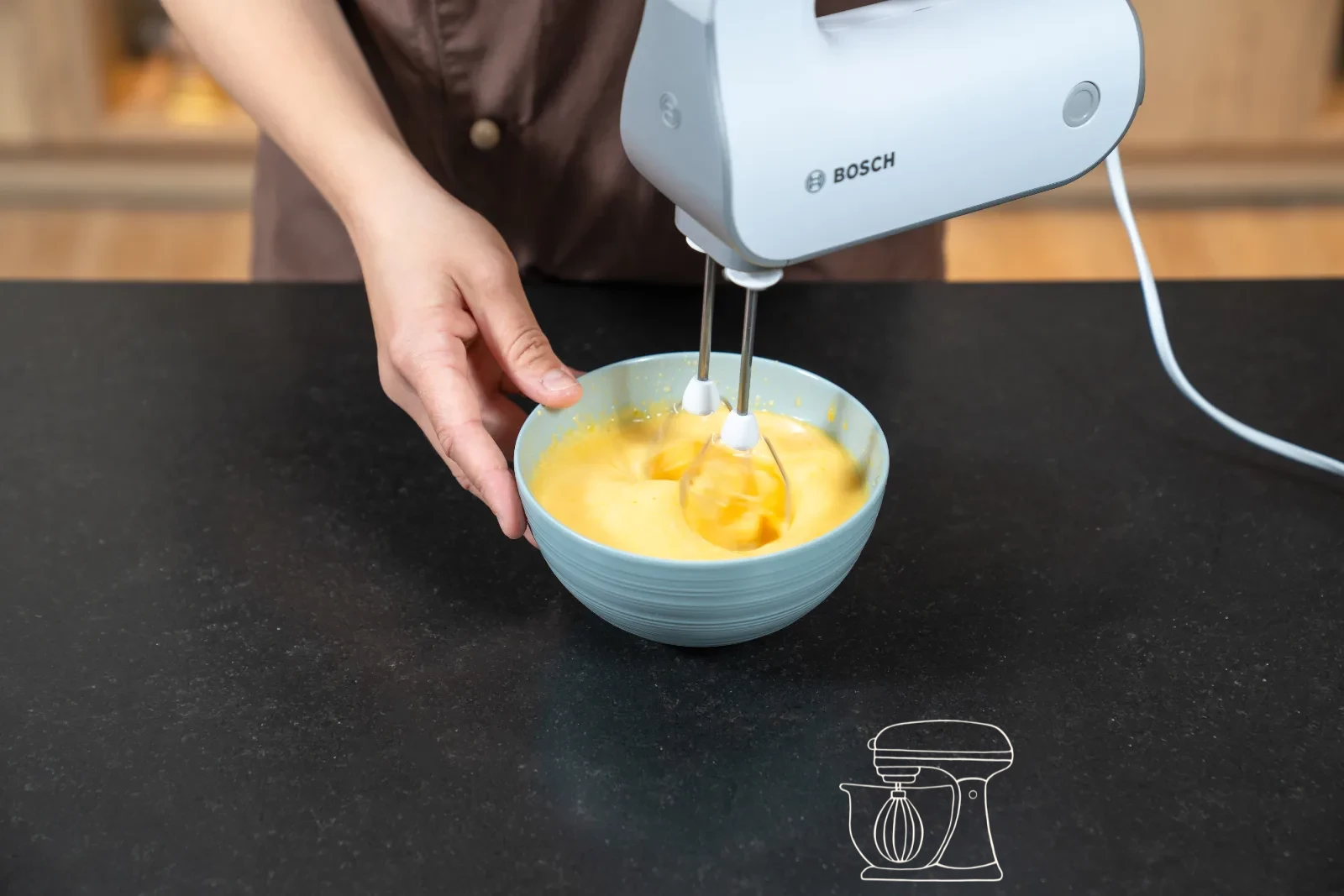 Pale egg-yolk-and-sugar foam in a bowl, with glossy whipped egg white beside it