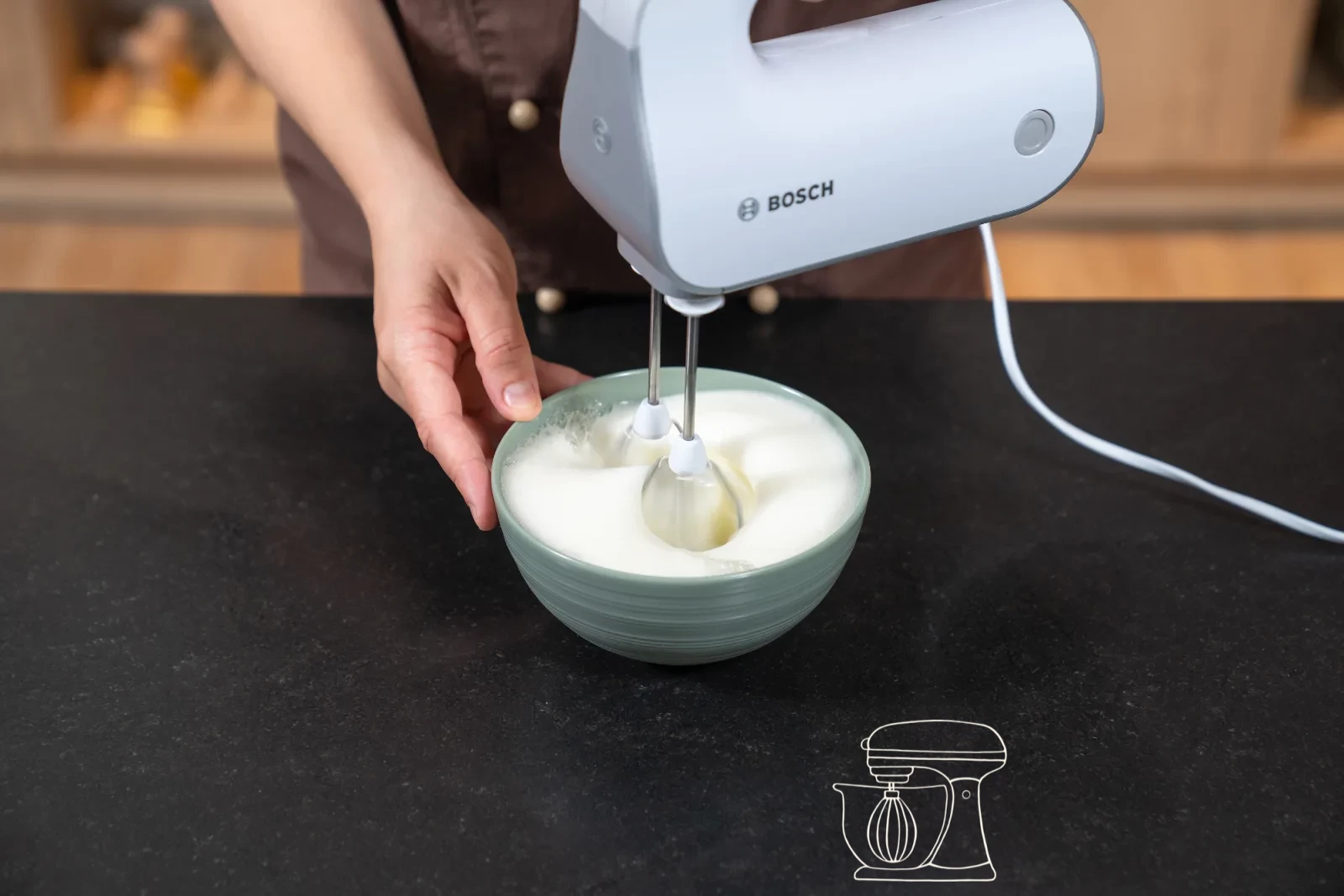 Pale egg-yolk-and-sugar foam in a bowl, with glossy whipped egg white beside it