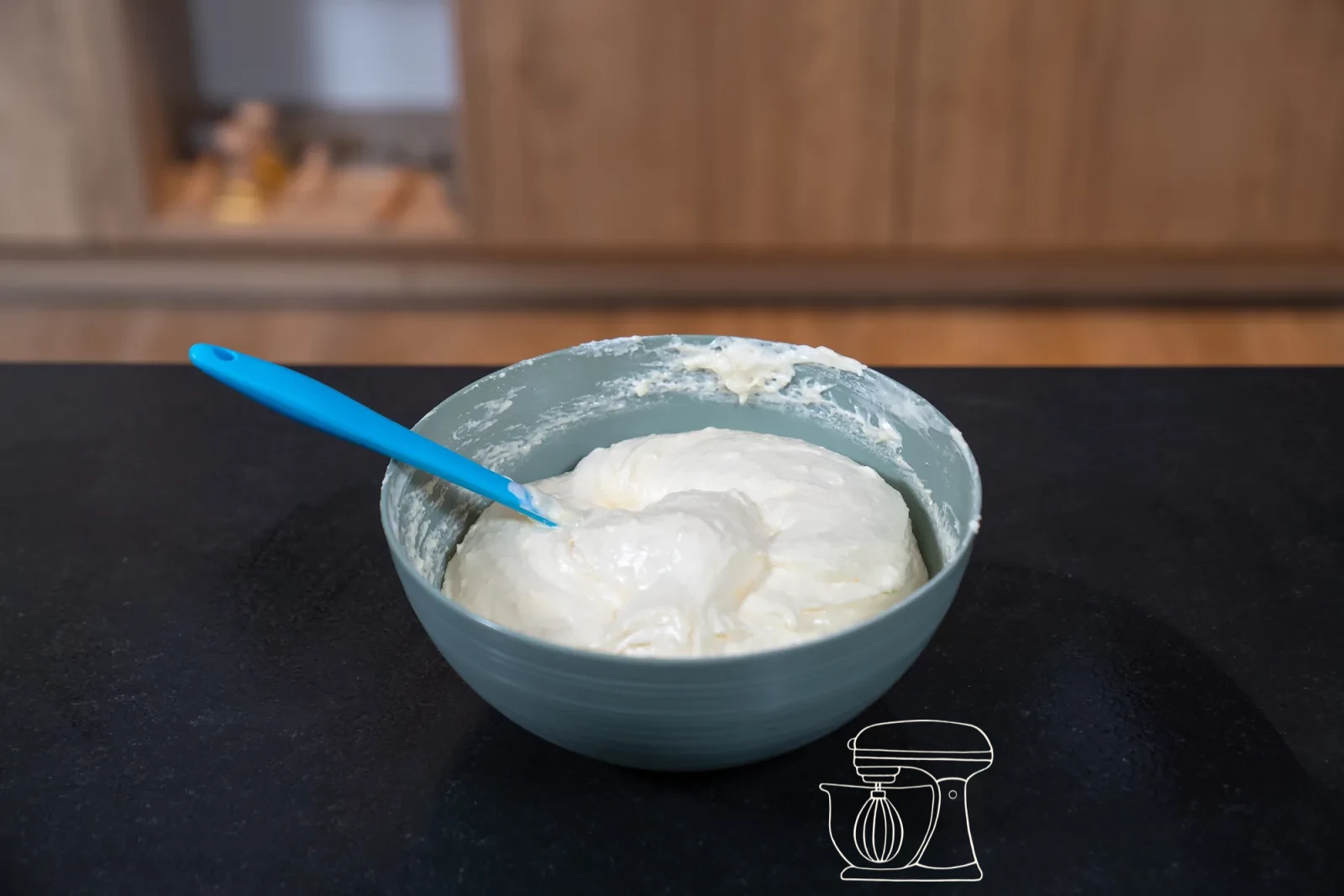 Pale egg-yolk-and-sugar foam in a bowl, with glossy whipped egg white and a sieve of flour beside it