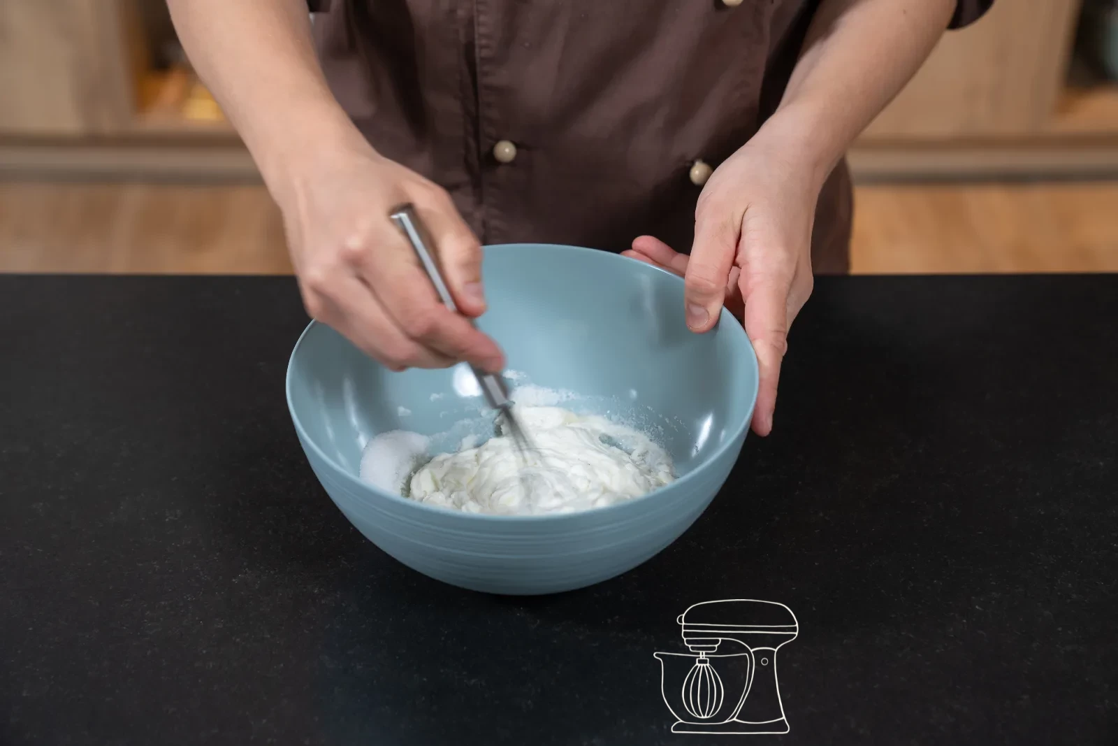 Creamy quark mixture in a bowl, a dough scraper folding in whipped cream in three portions