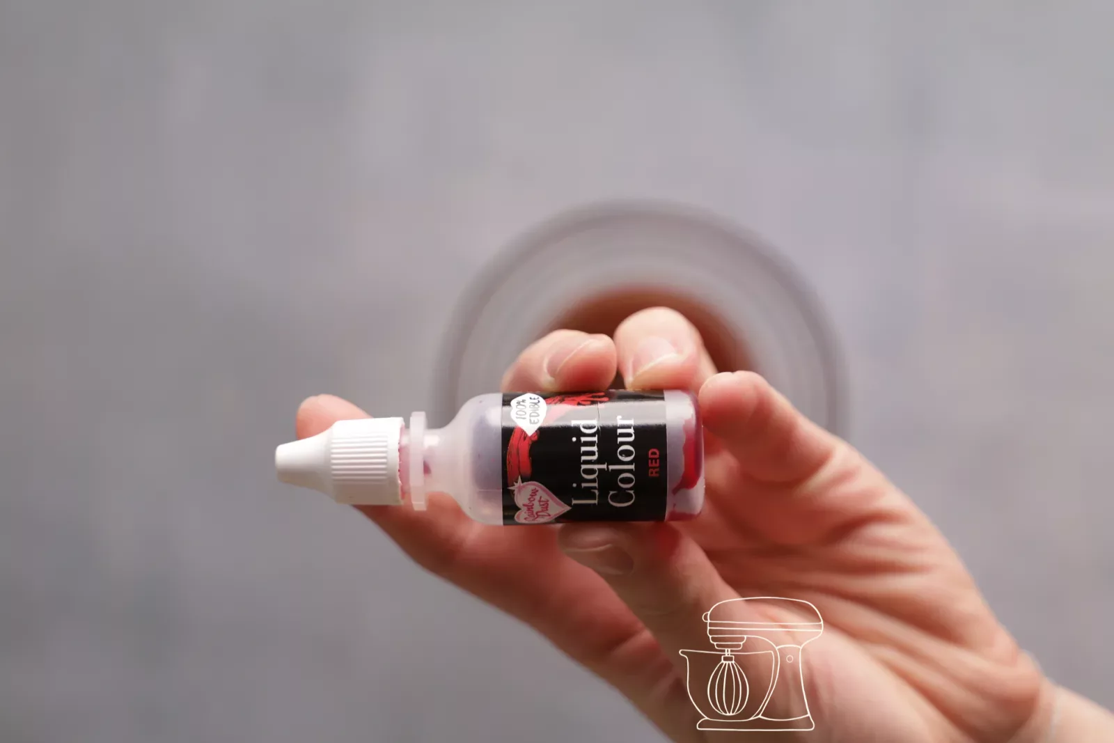Red airbrush color is added drop by drop into the mixture