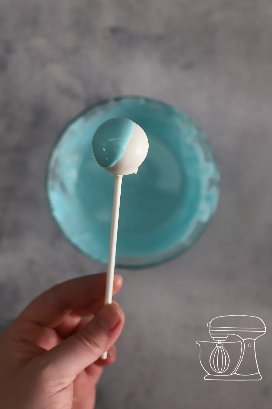 Weissen Cake Pop halb in Hellblau tauchen