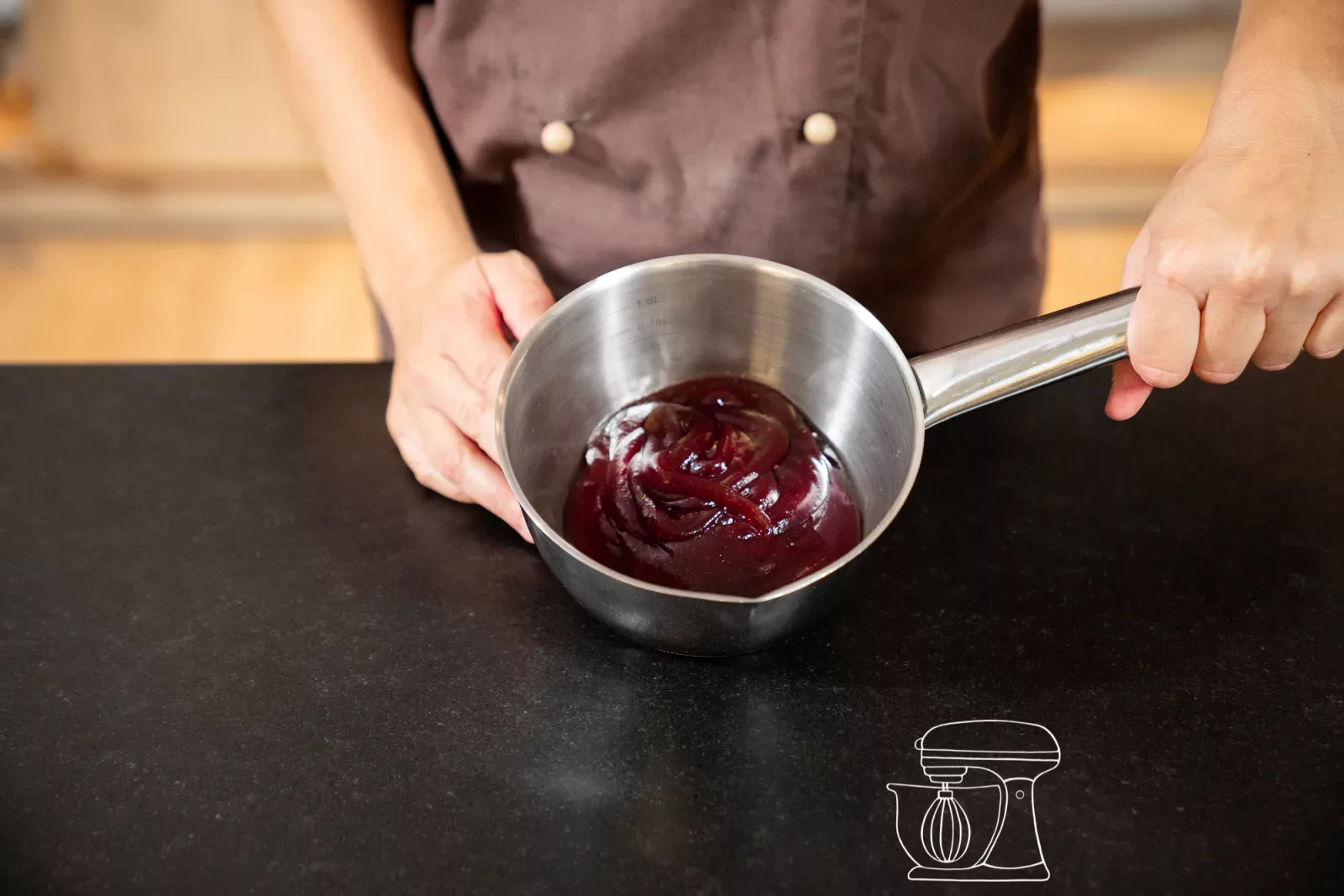 Raspberry jam being stirred smooth in a pan with the Whisk