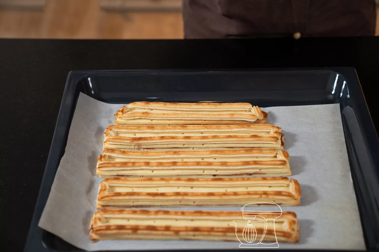 Browned railway worker recipe biscuit strips with golden brown almond rails on the Baking tray