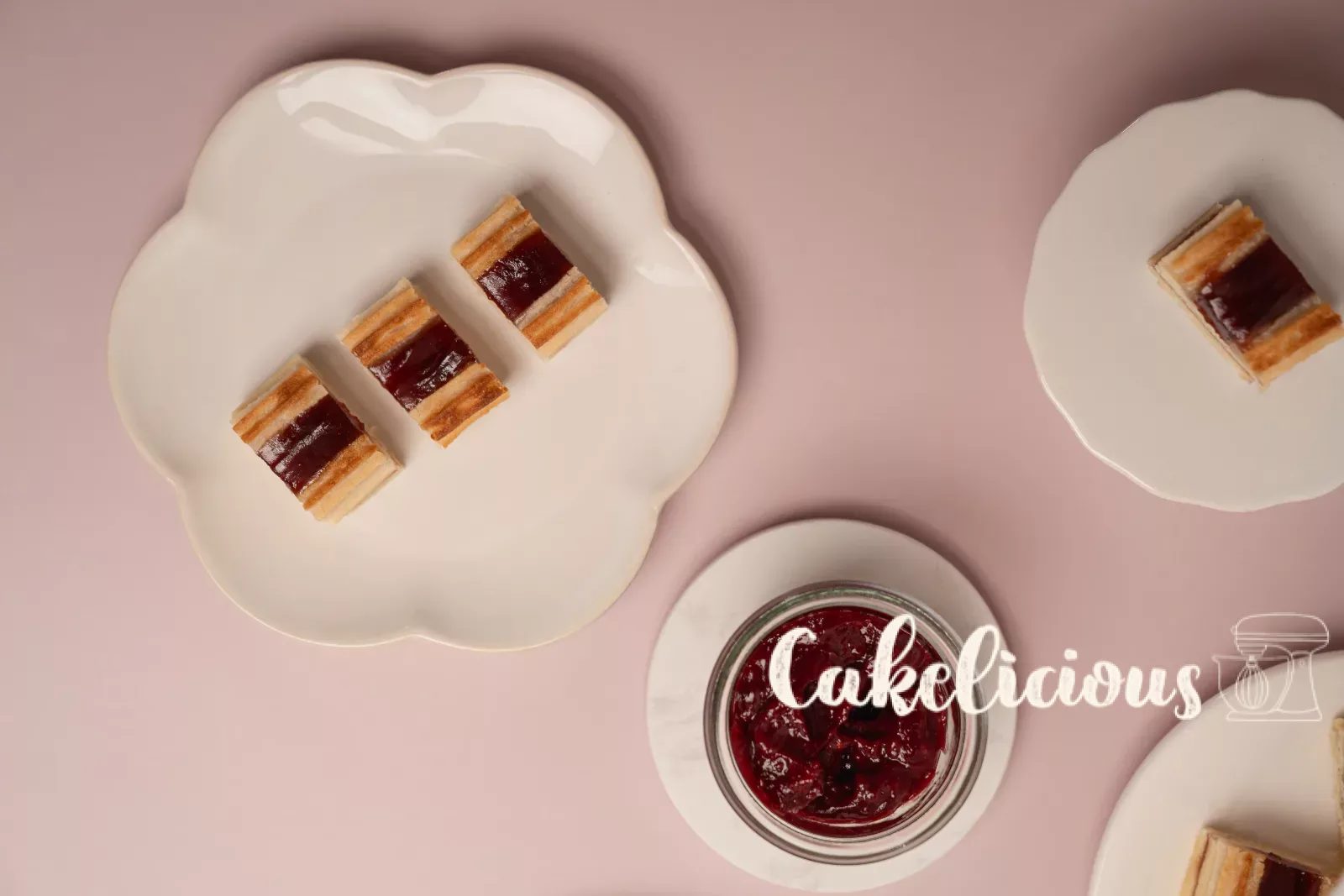 Single railway biscuit on a mini cake stand, with plates of more biscuits behind