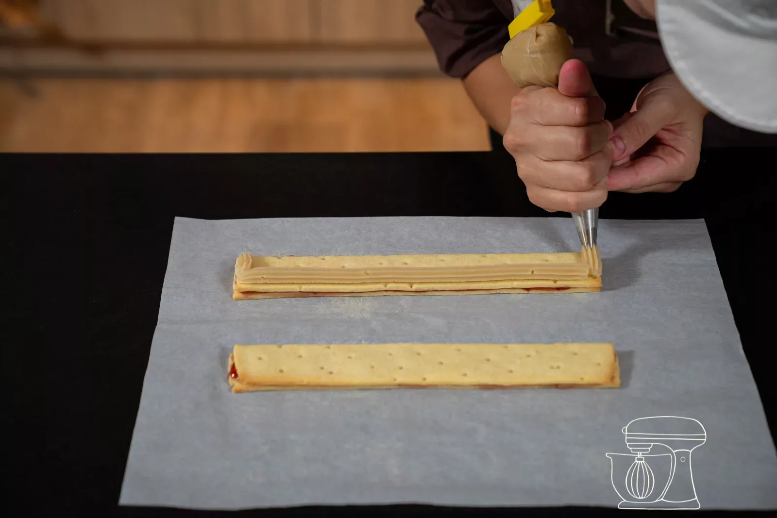 Second strip of almond paste being piped on the opposite side