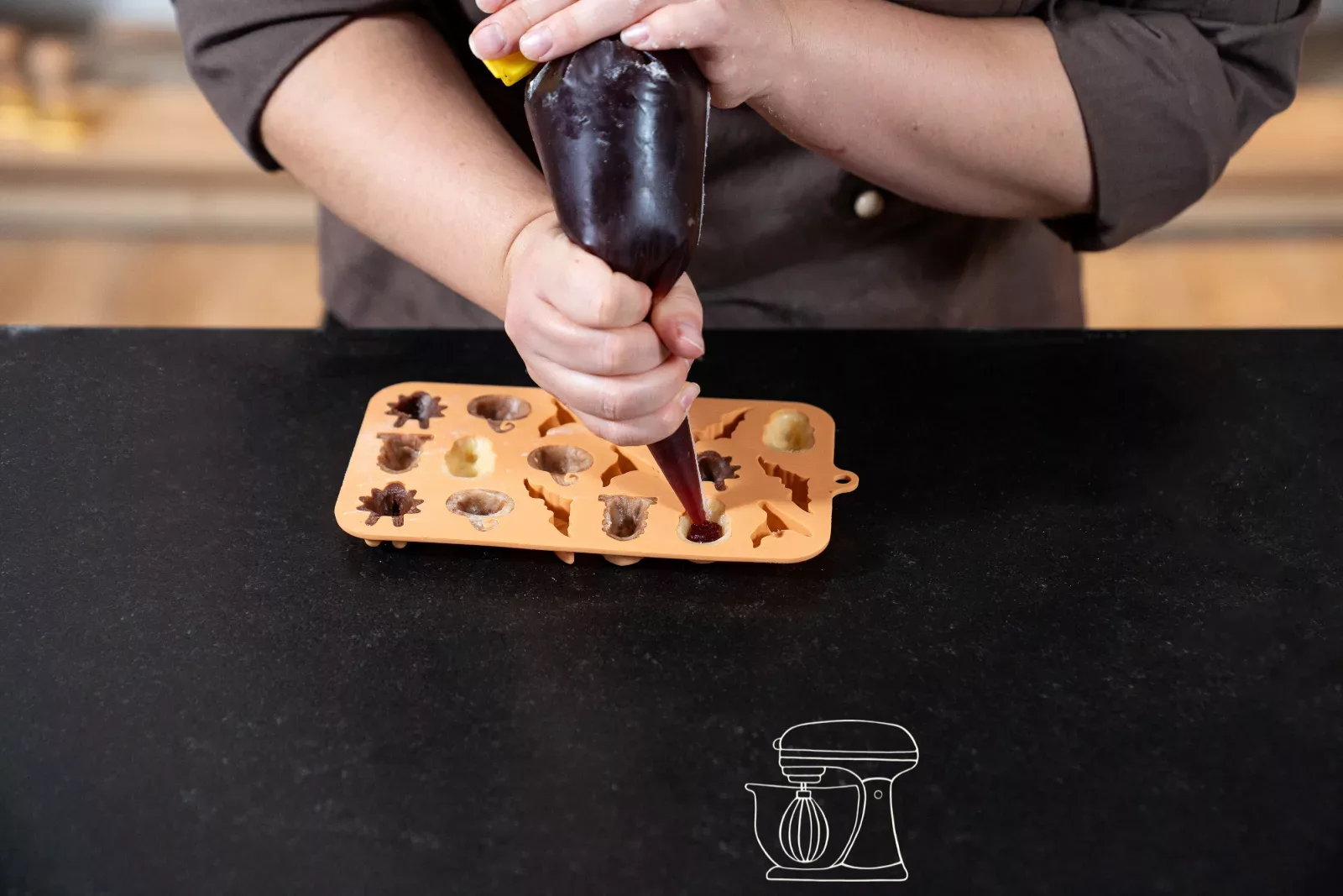 Add the berry filling into the dough cavities with the Dosing bottle