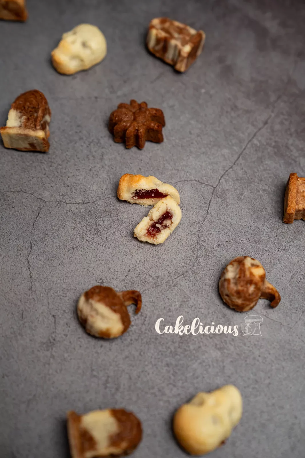 A cut Halloween biscuit with berry filling