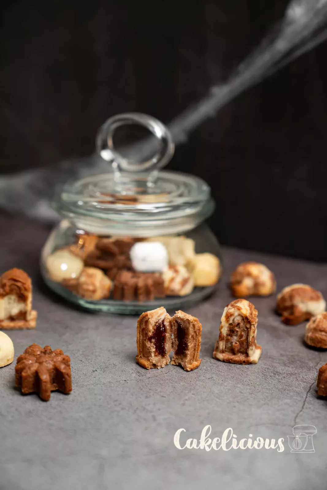 Filled gravestone biscuits in front of a jar full of Halloween biscuits