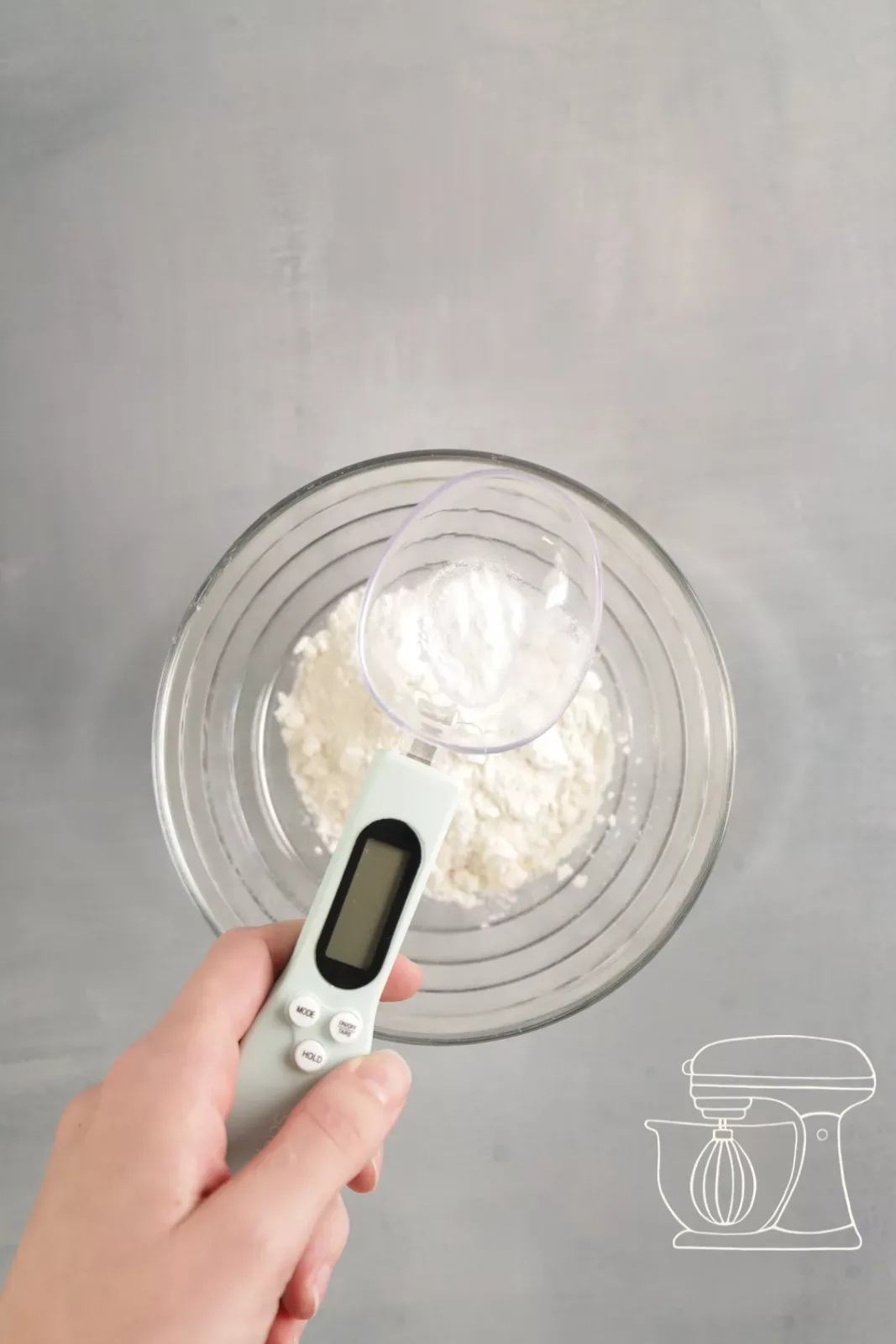 Baking powder being weighed accurately with a spoon scale