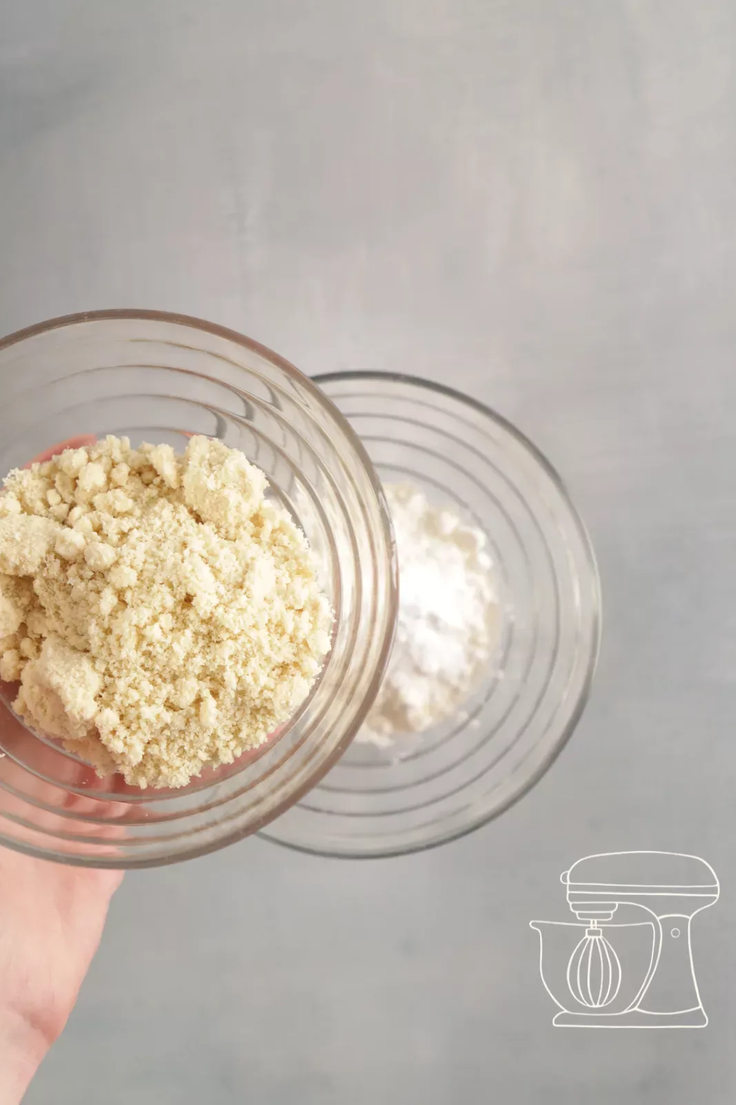 Flour and almond powder being added to a bowl