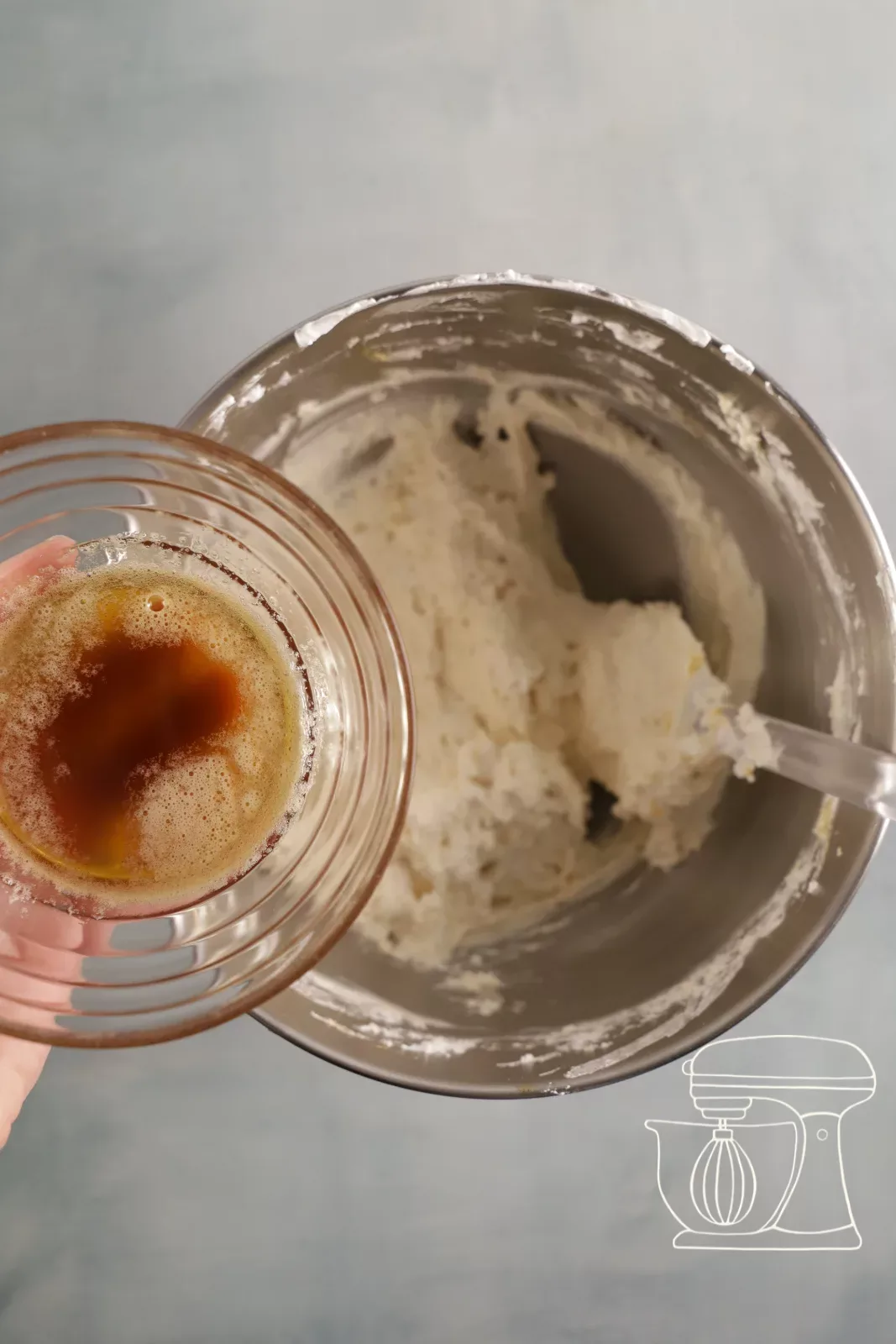 Browned butter being poured into the Financier mixture