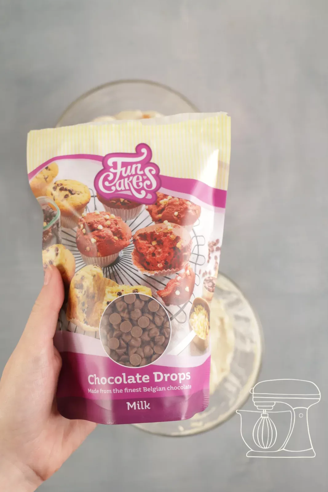 Milk chocolate drops being sprinkled into the second bowl