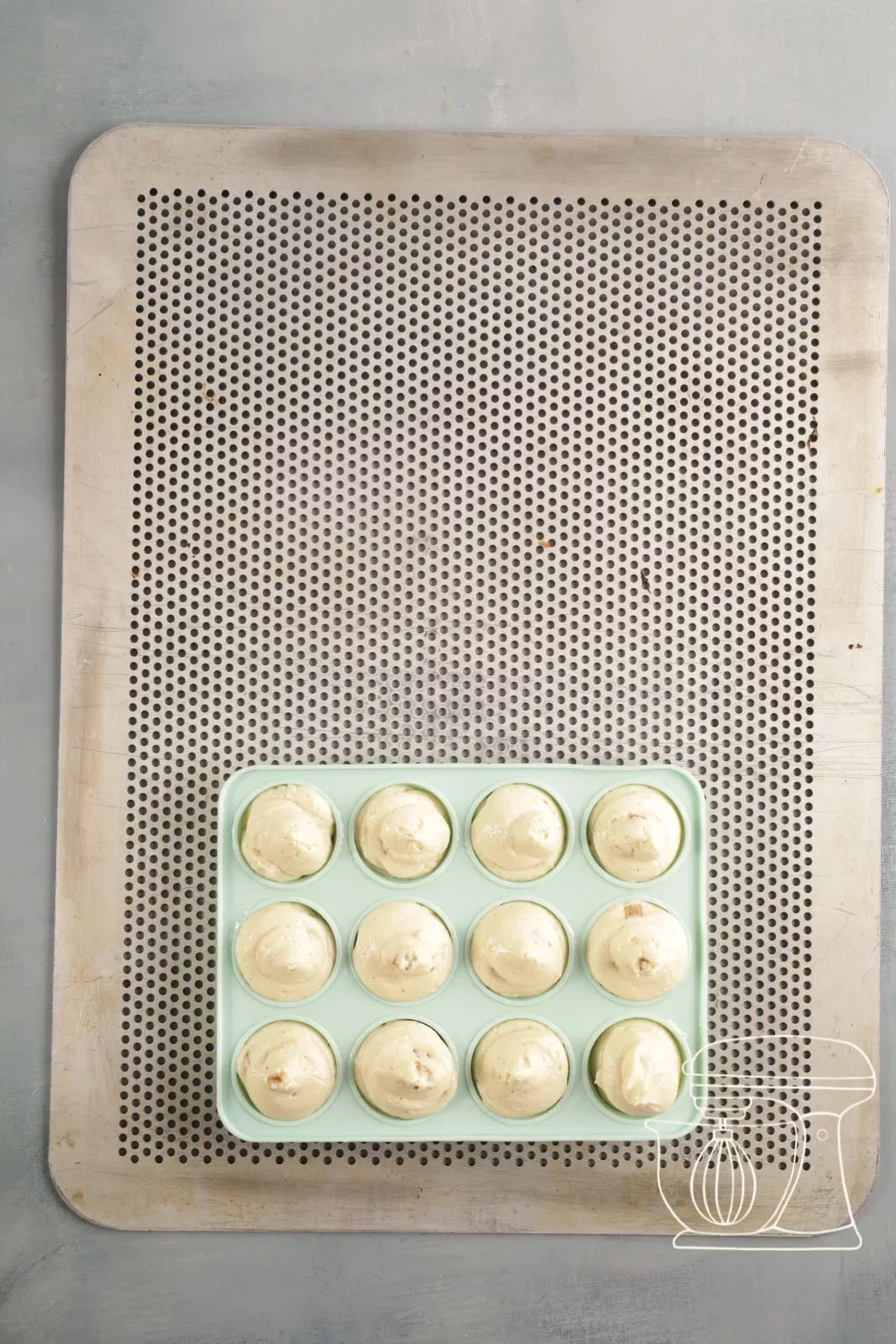 Upper part of the cake pop baking tin being sprayed
