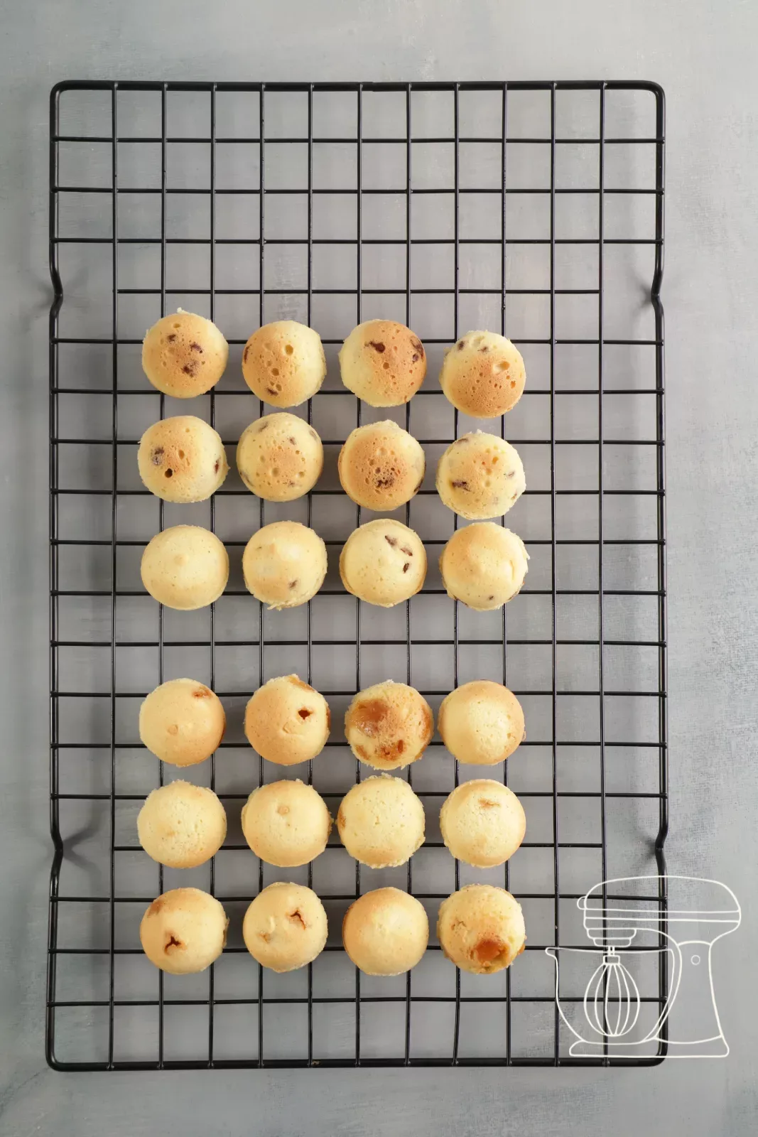 Round financier cake pops cooling on a cake rack