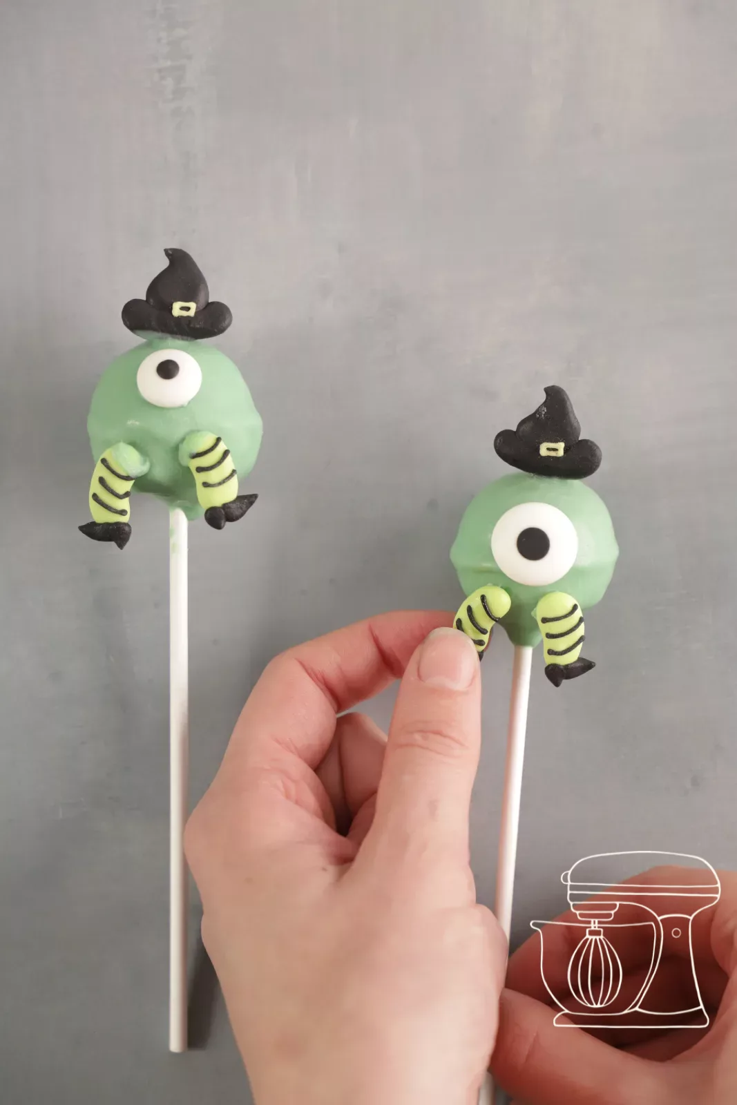 Candy feet being attached to the monster cake pop with Deco melts