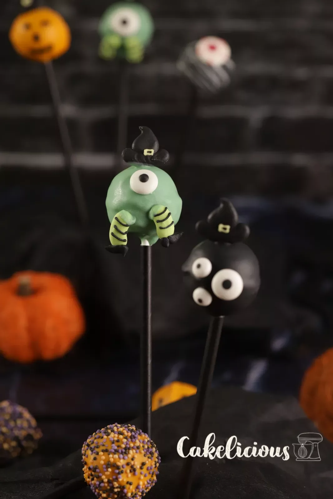 Halloween cake pops as ghosts, pumpkins and monsters on a Styrofoam stand