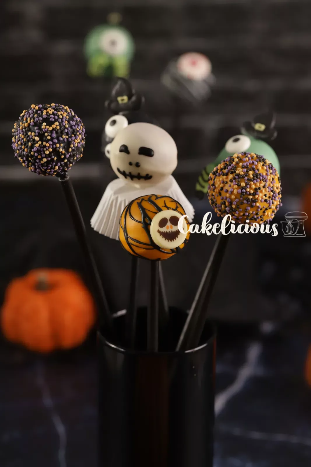 Halloween cake pops as ghosts, pumpkins and monsters on a Styrofoam stand