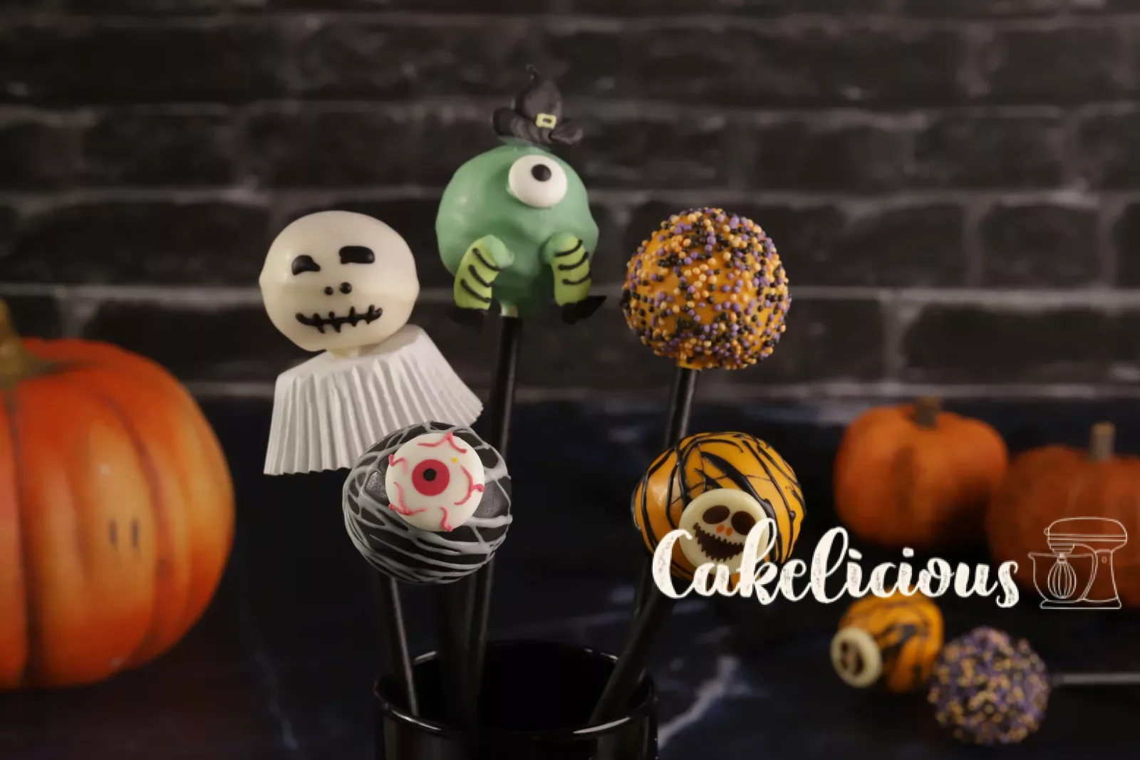 Halloween cake pops as ghosts, pumpkins and monsters on a Styrofoam stand