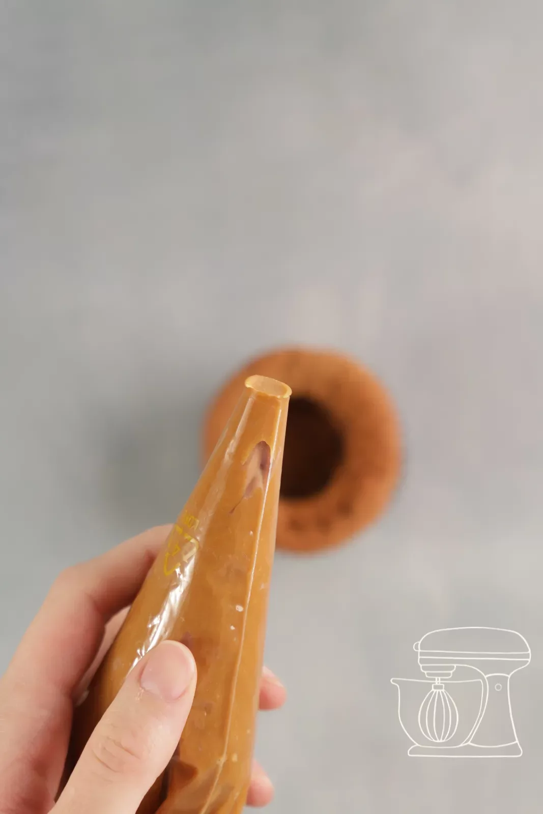 Karamellfüllung wird in den ausgehöhlten Cupcake gespritzt