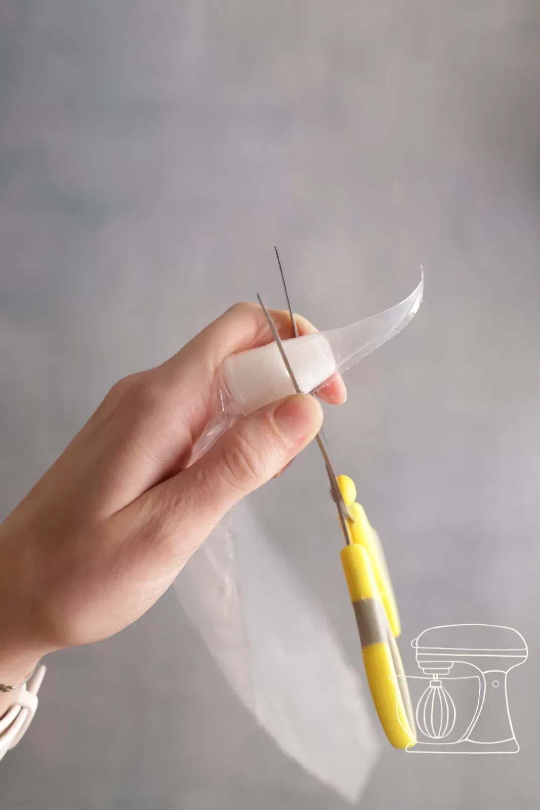 Tip of the piping bag is cut off with scissors