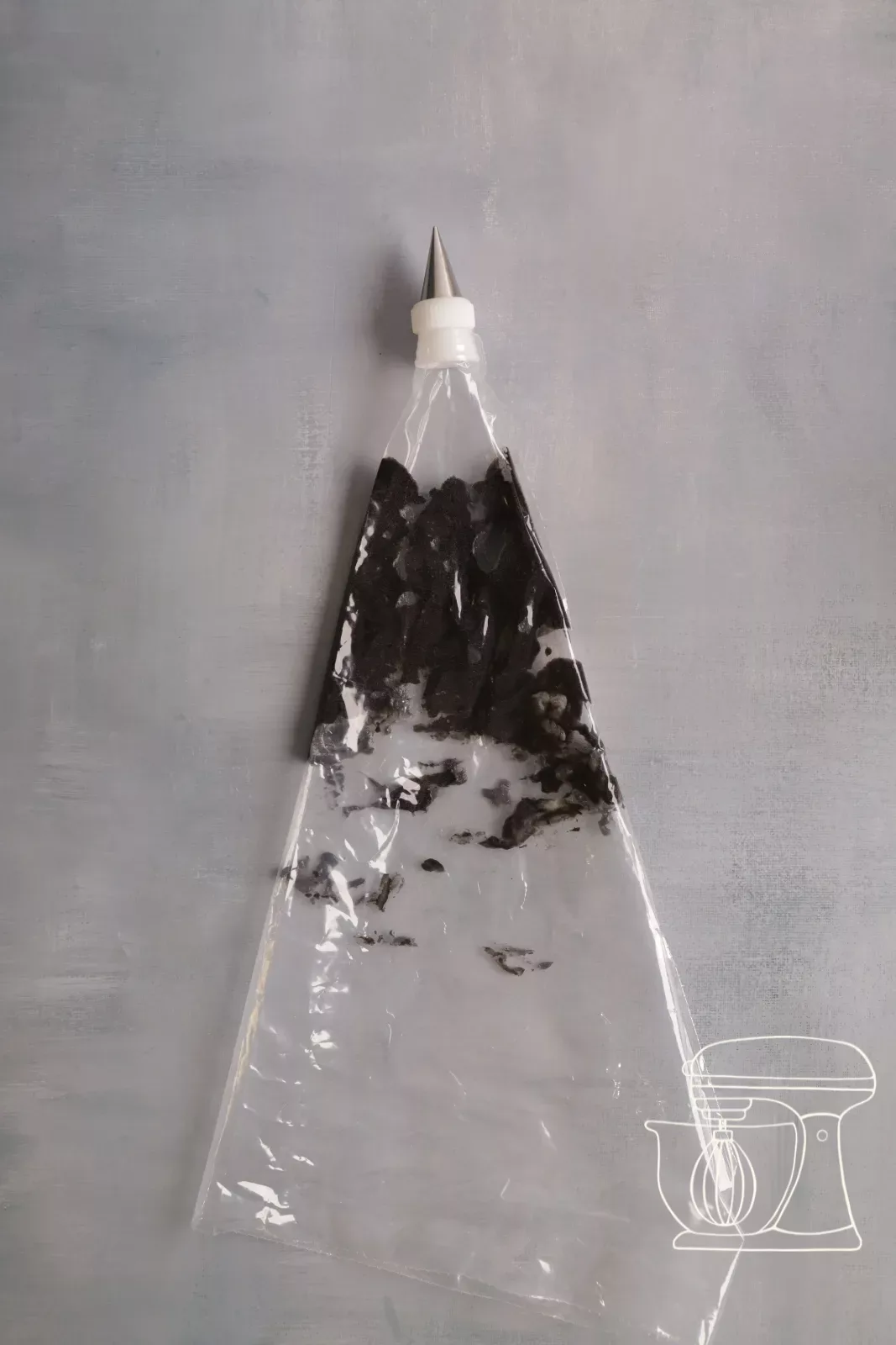 Black cigarette paste is filled into the piping bag