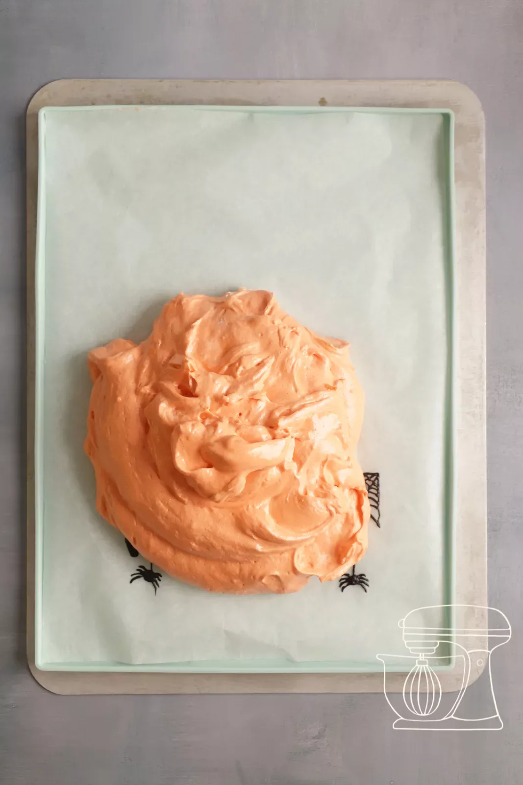 Orange batter being poured onto the frozen Roulade mat