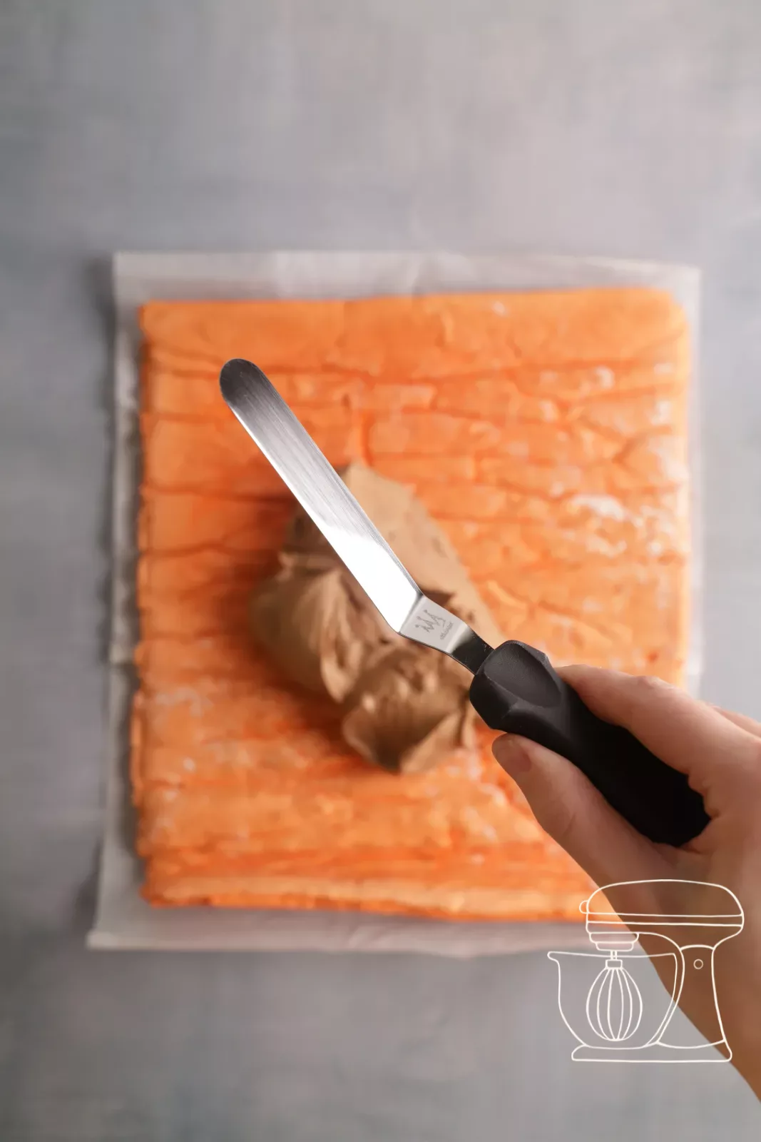 Ganache being spread on the sponge with the Angled spatula