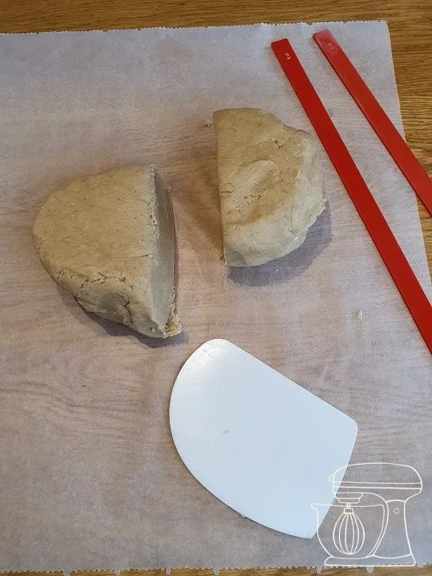 Dough being halved with a Dough scraper