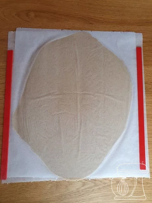 Rolled-out dough on a perforated tray ready for the freezer