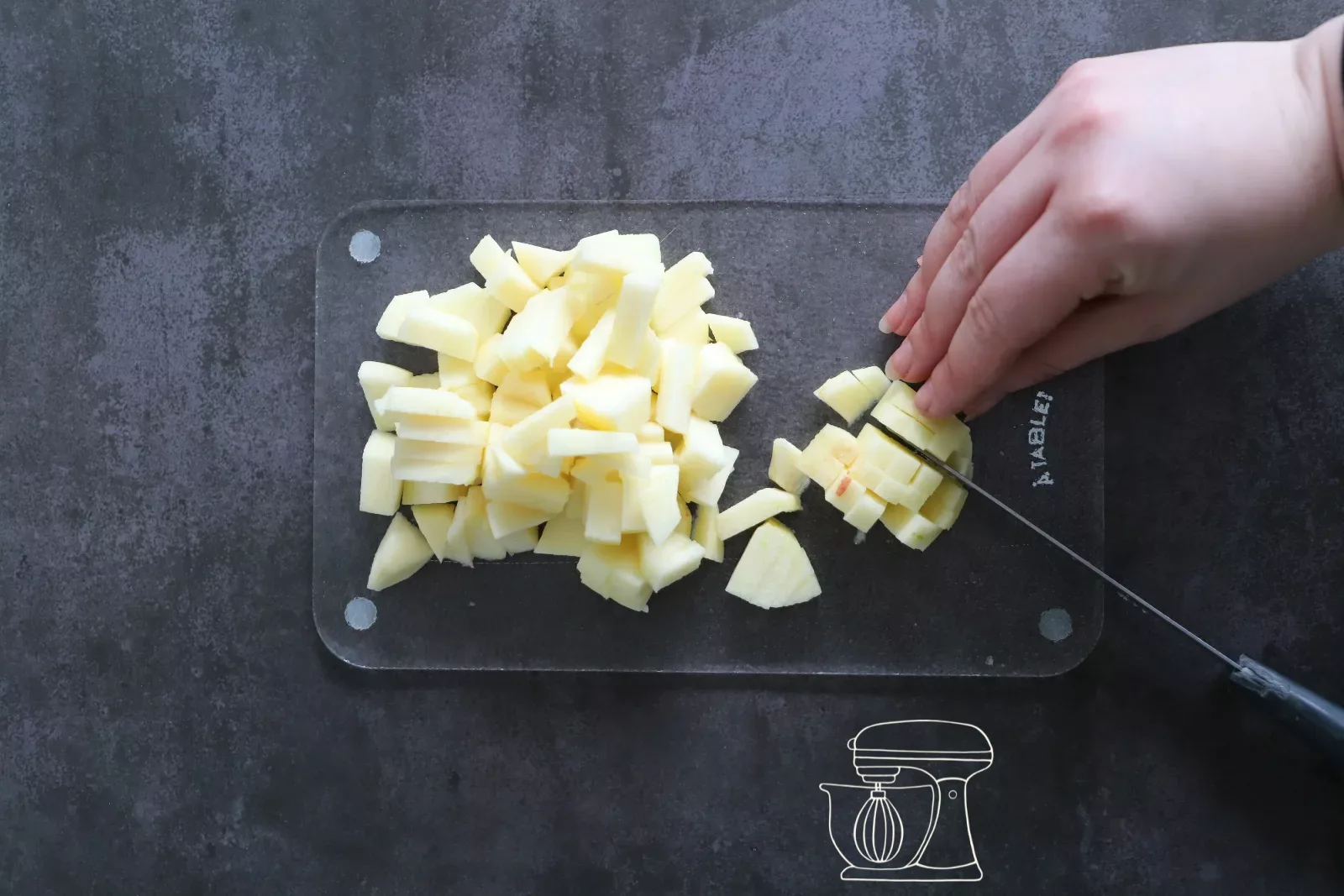 Apples being cut into small cubes