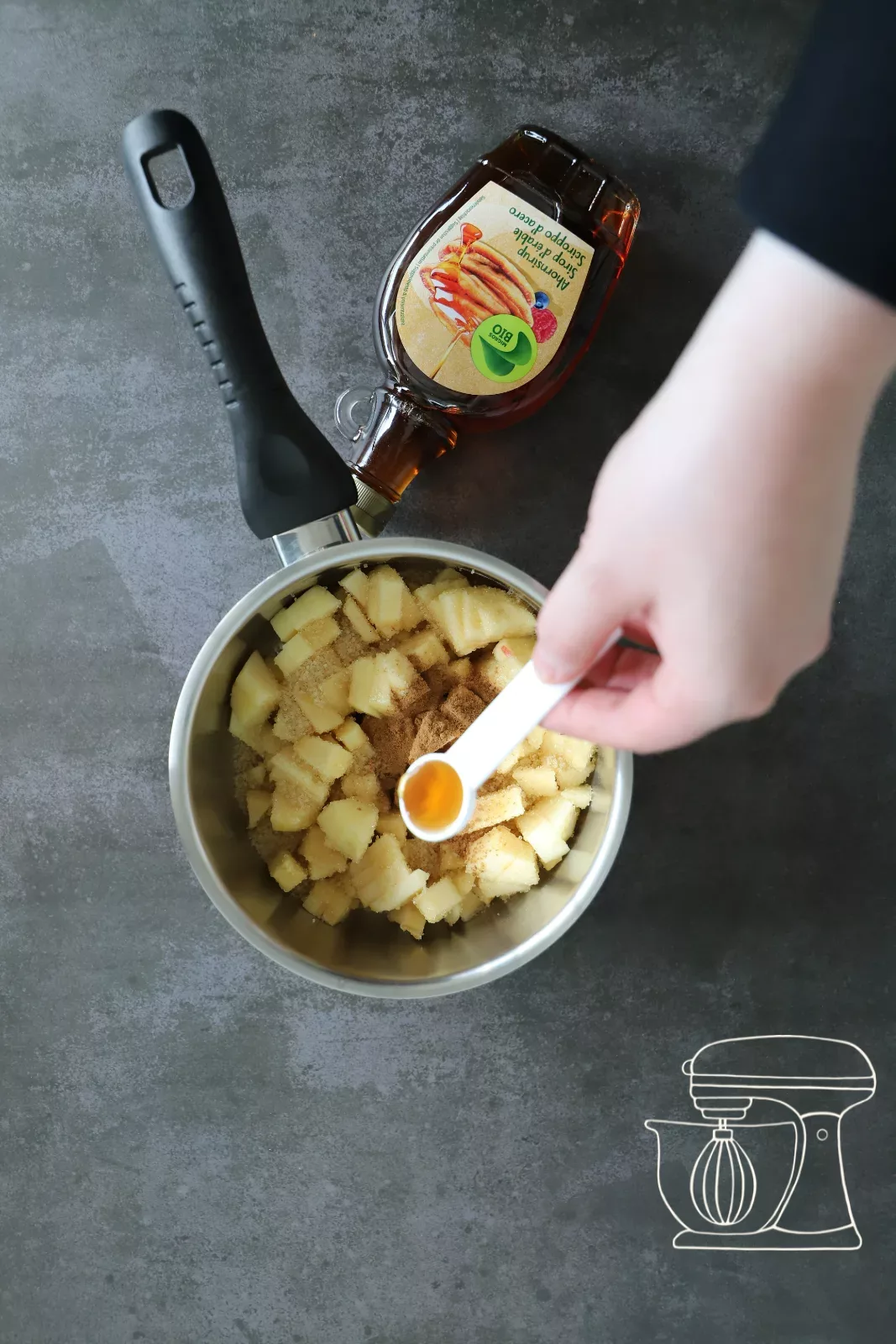 Maple syrup being poured into the pot