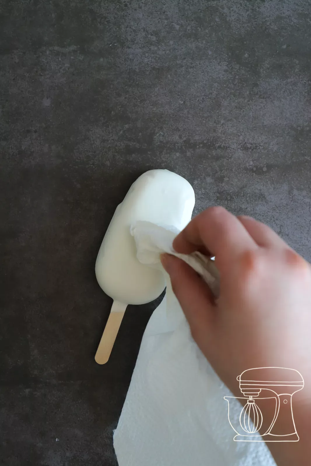 Deco melts being piped in fine lines over the cakesicle