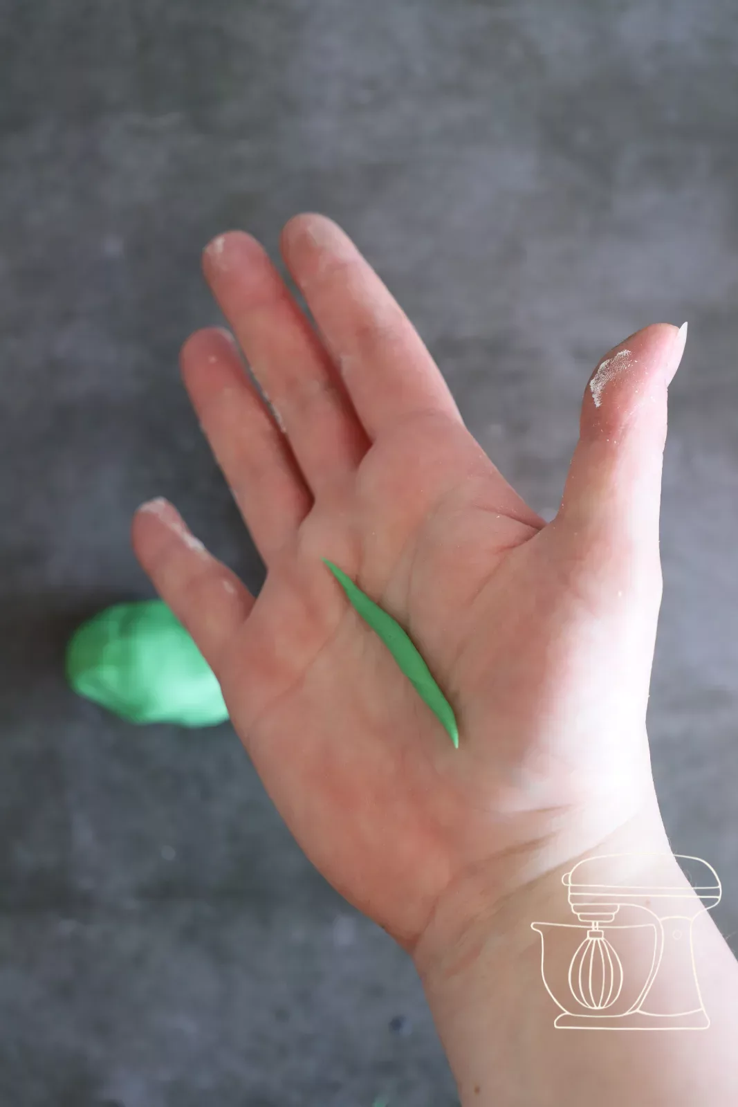 Fondant being shaped into a twisted pumpkin stem