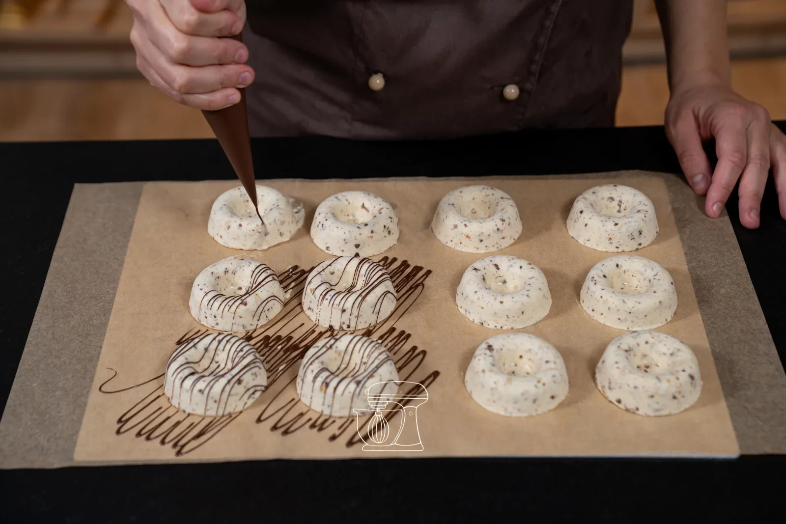 Caramel cream being piped into the hollow of the parfaits with a piping bag