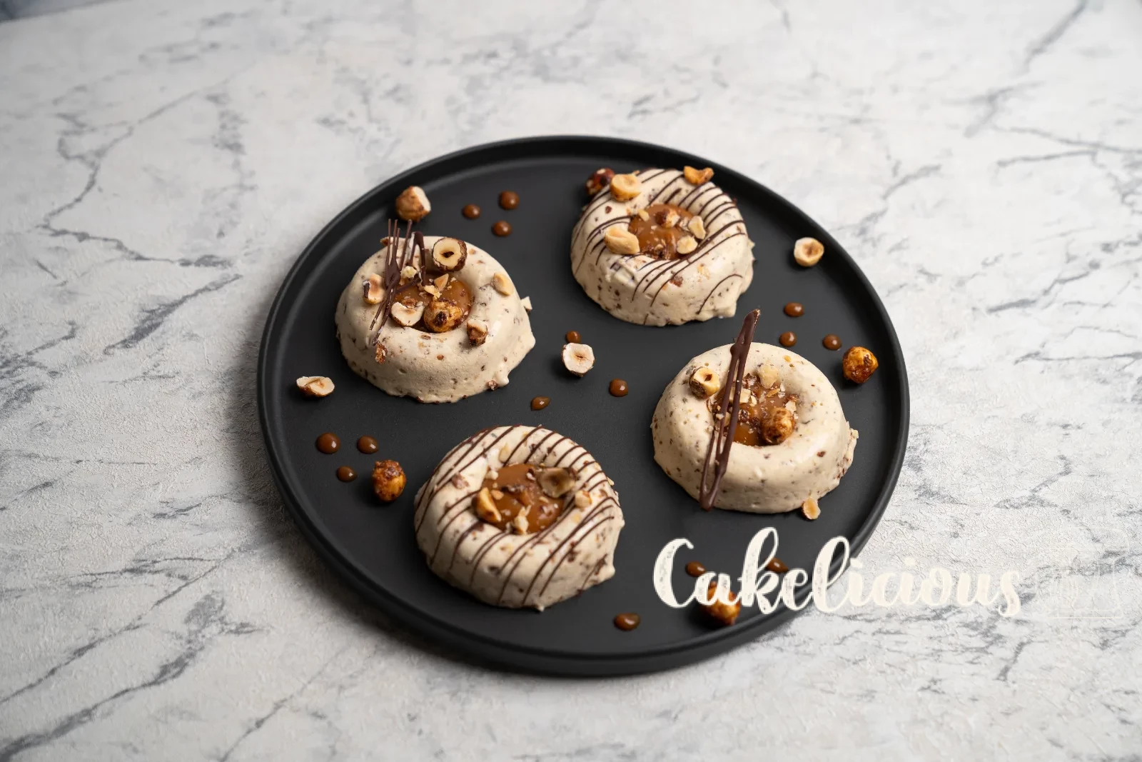 Hazelnut caramel parfaits from above, with copper spoons on a woven coaster