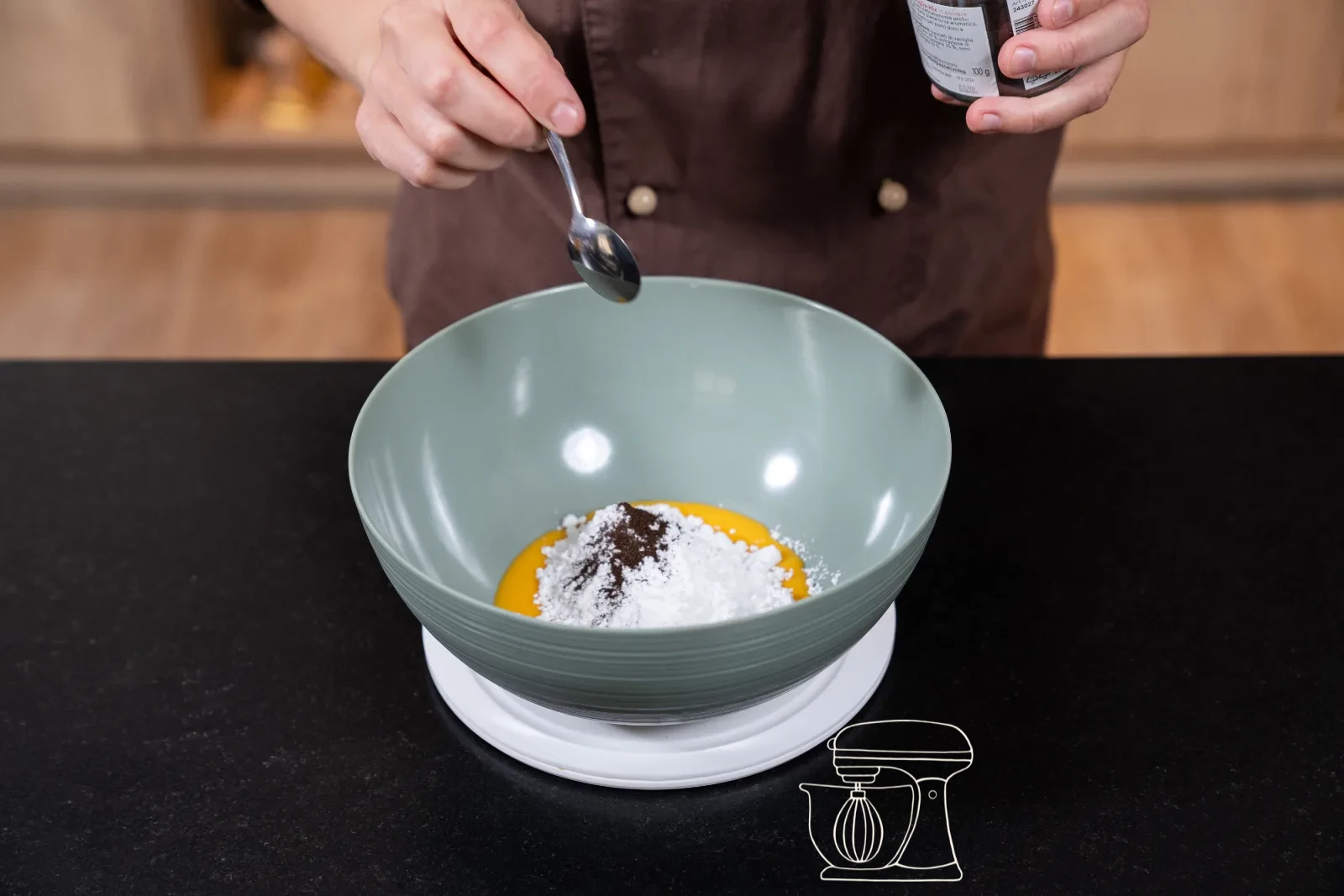 Egg yolks, icing sugar and vanilla seeds in a bowl on the scale