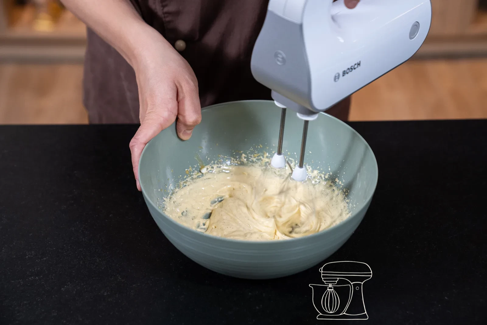 Egg yolk mixture being whipped pale and airy with the hand mixer